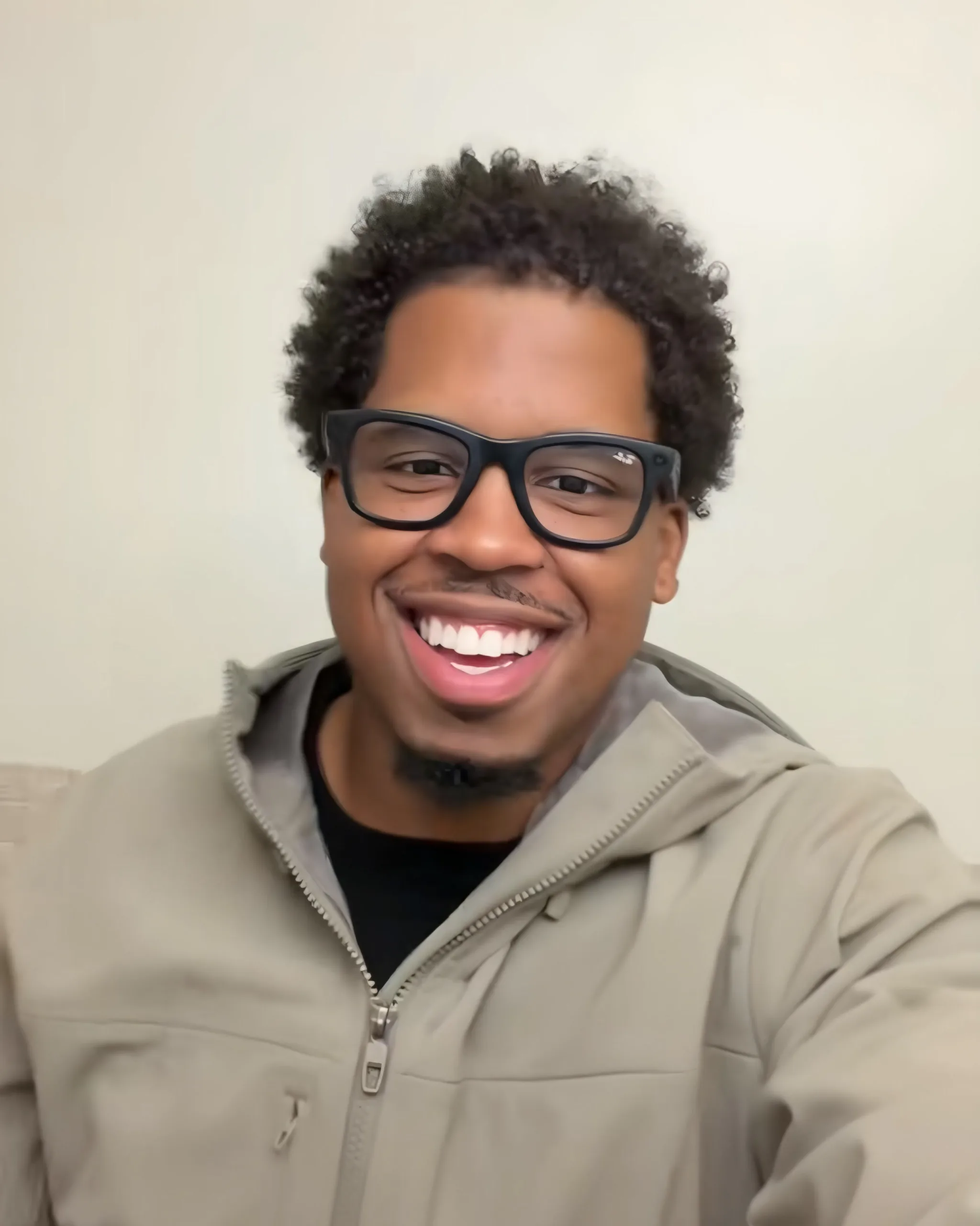 Dany Jeanpaul, owner of Rapid Haul Services, smiling in glasses and a gray jacket.